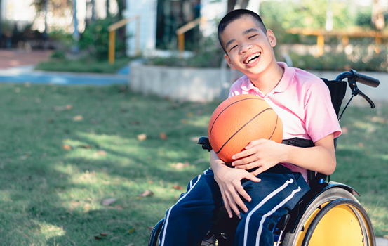 boy in wheelchair on accessible playground
