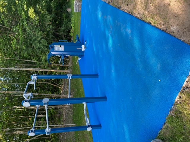 Man performing a push-up using Outdoor-Fit Trail-Fit bars at MOVE Outdoor Fitness Park.