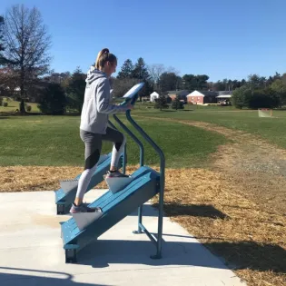 A woman exercising using EVEREST Cardio Climber
