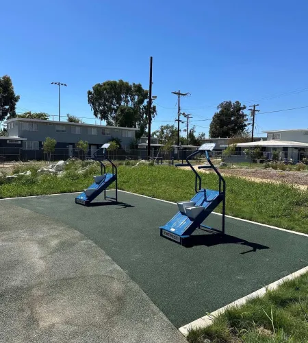 ADA-accessible parallel bars at an outdoor gym in a Los Angeles housing development